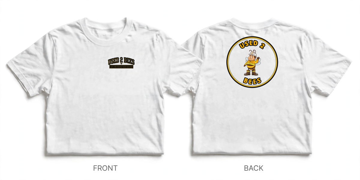 Front and back heavyweight tee mockup: small USED 2 BEES chest logo on the front and a realistically scaled firefighter bee print centered on the upper back